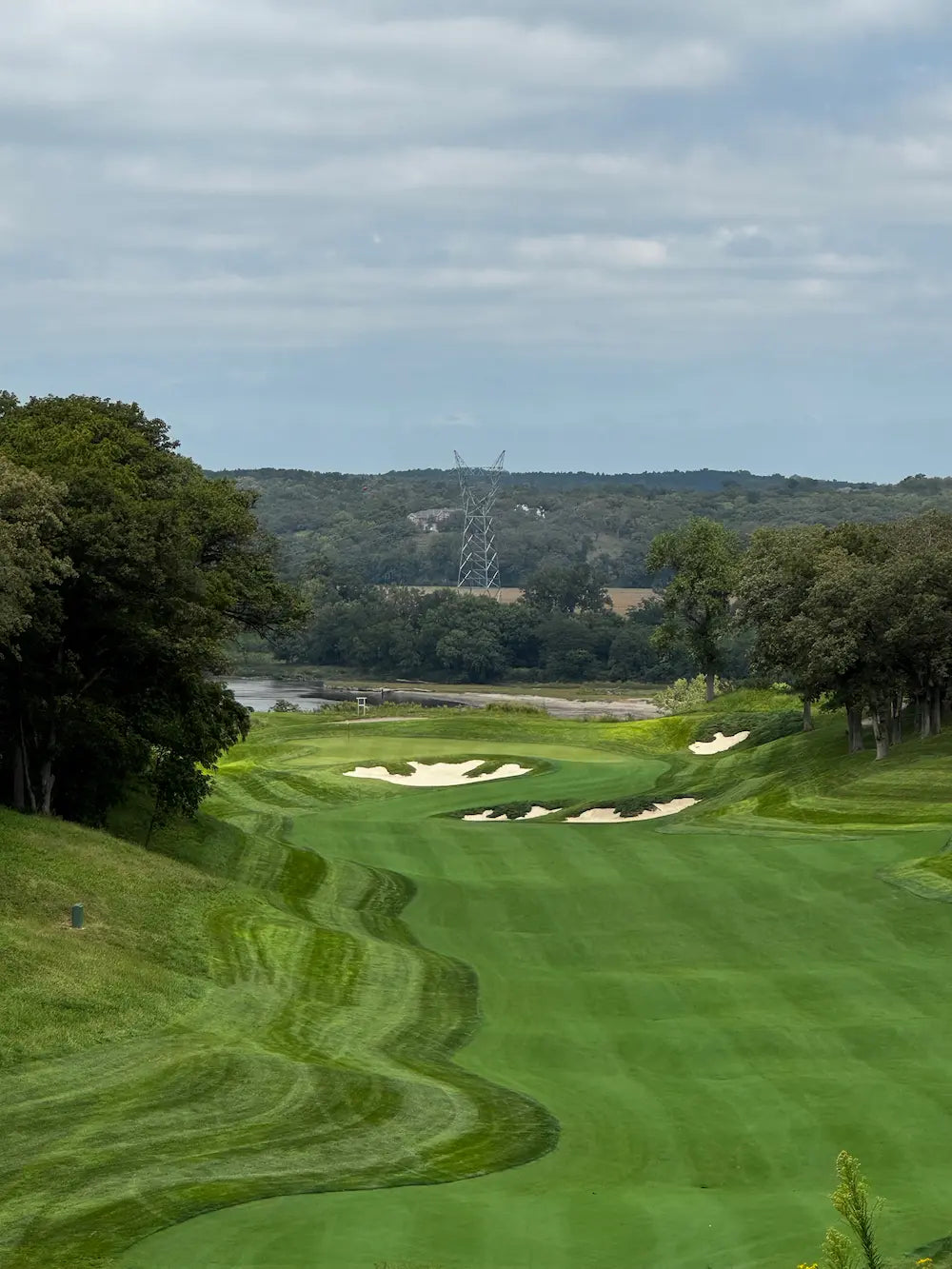Quarry Oaks Golf Club in Nebraska is a place where mental wellness happes. Beautiful picture of golf hole layout with river in background.