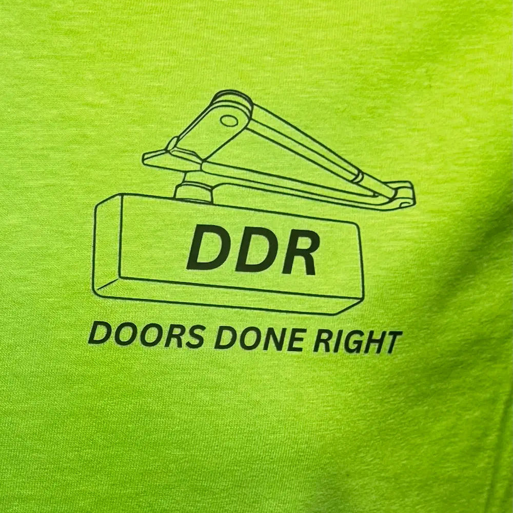 Doors Done Right Logo on a green shirt from Green Ferret Golf