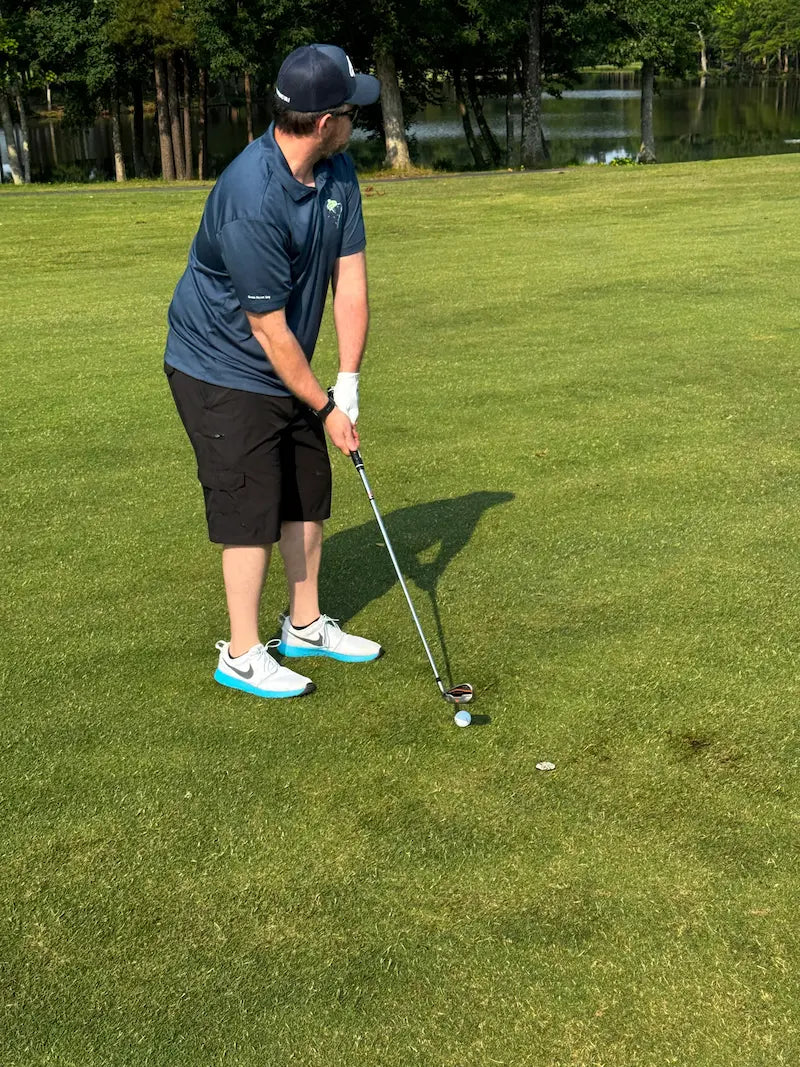Dusty lining up his shot in a Pro Shop Polo at the SVHS Charity Golf tournament at Emerald Lake in Charlotte