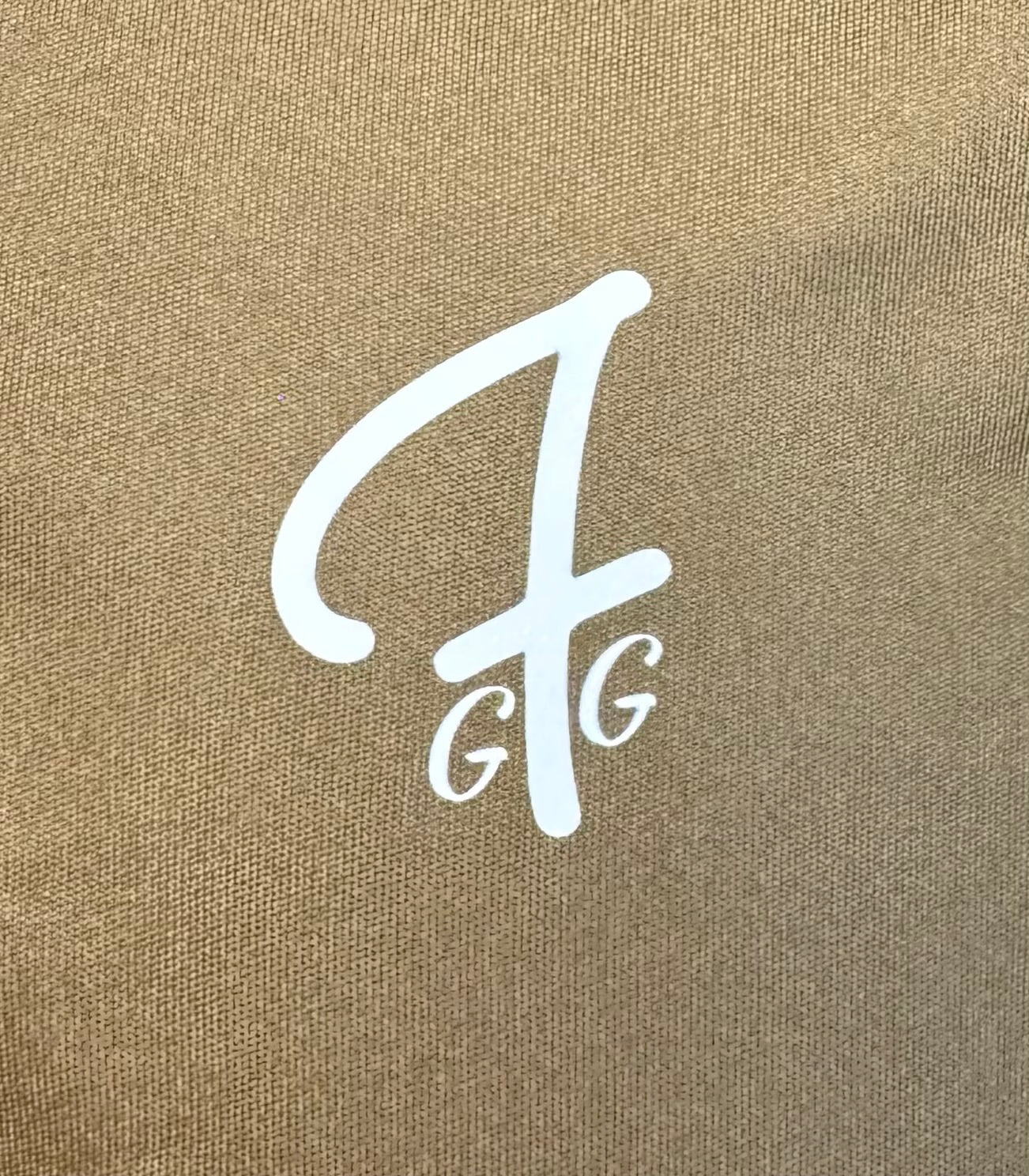 Close up of moisture-wicking fabric and GFG logo on a Green Ferret Golf polo