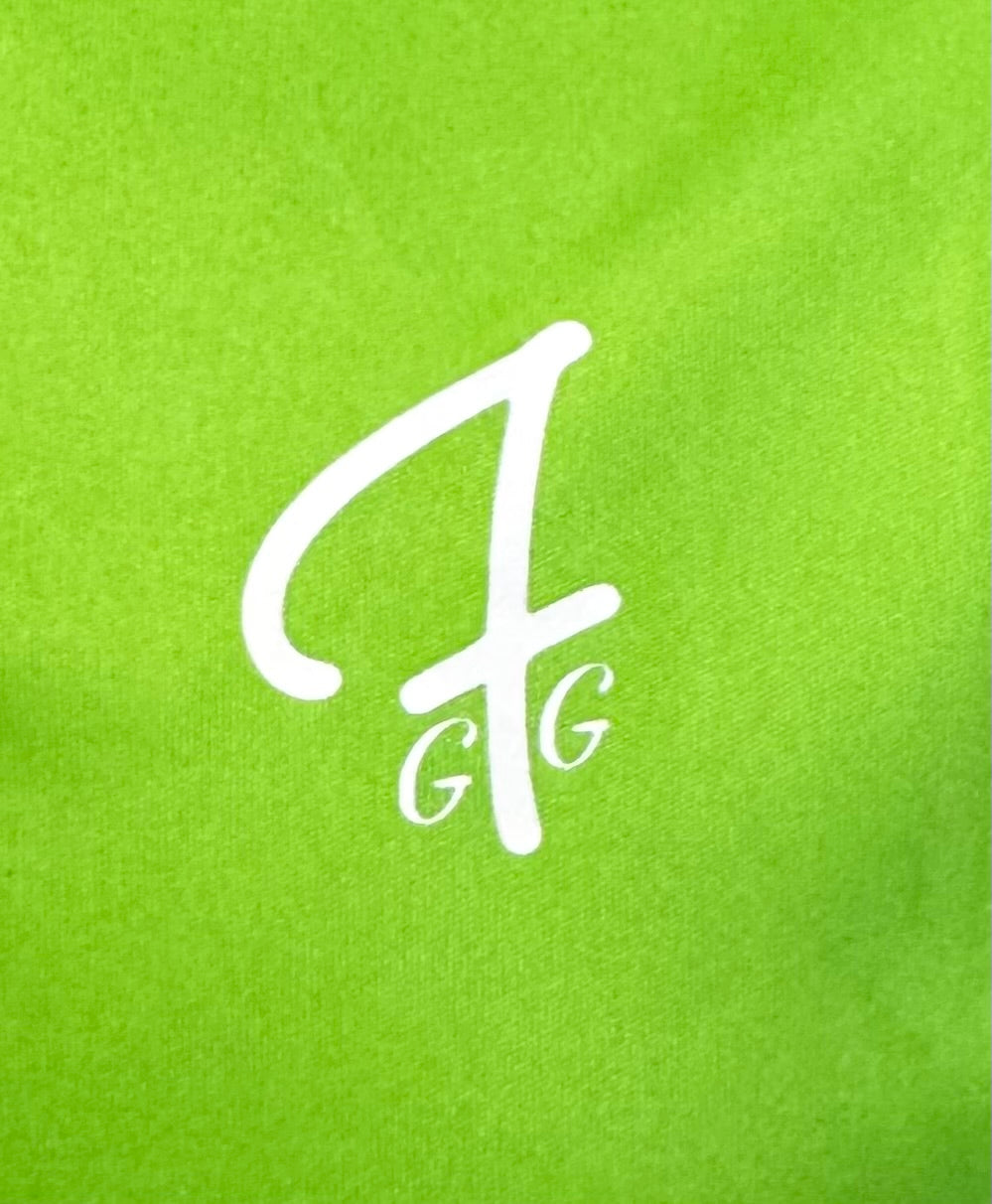 Close up of moisture-wicking fabric and GFG logo on a Green Ferret Golf polo
