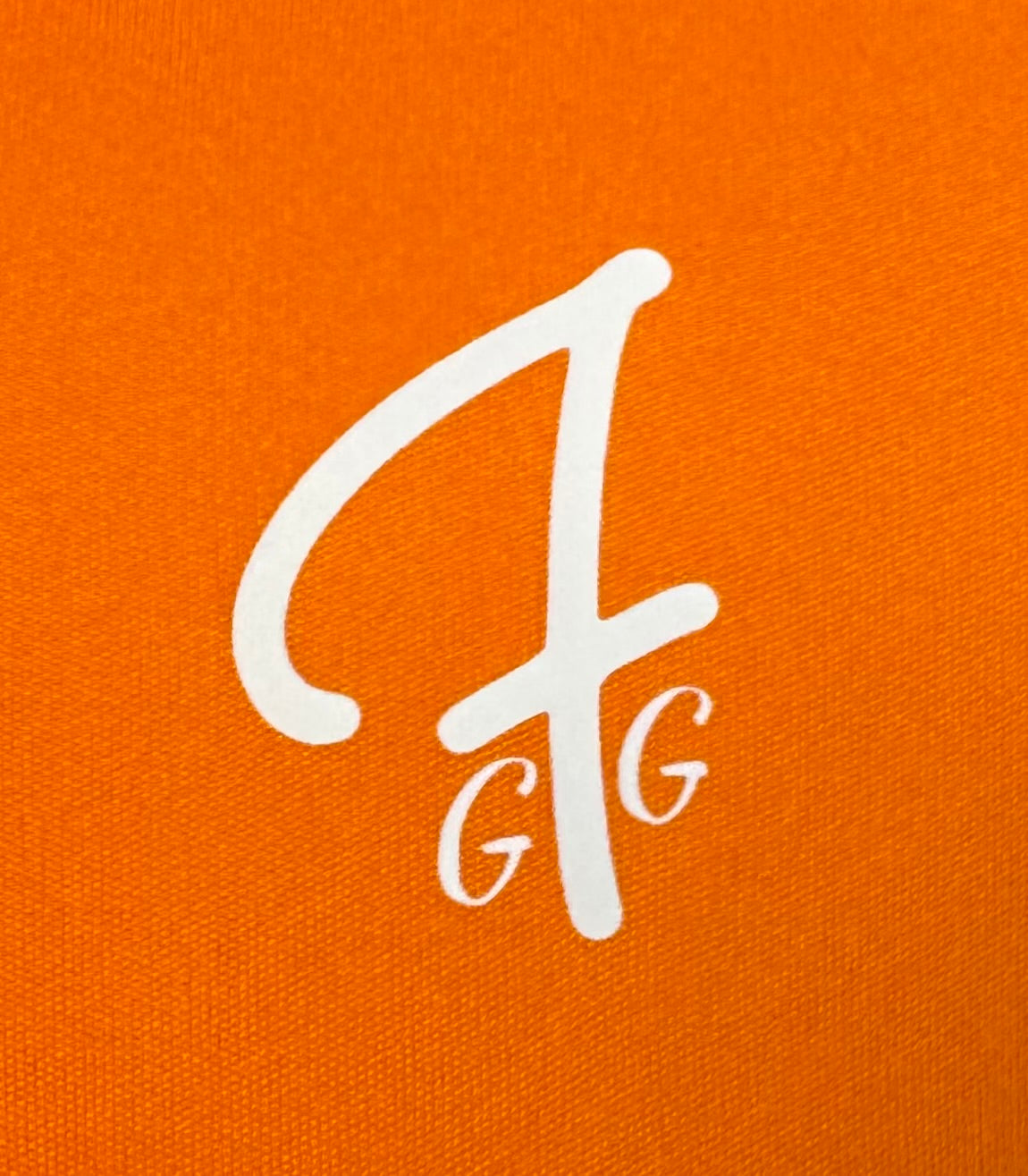 Close up of moisture-wicking fabric and GFG logo on a Green Ferret Golf polo