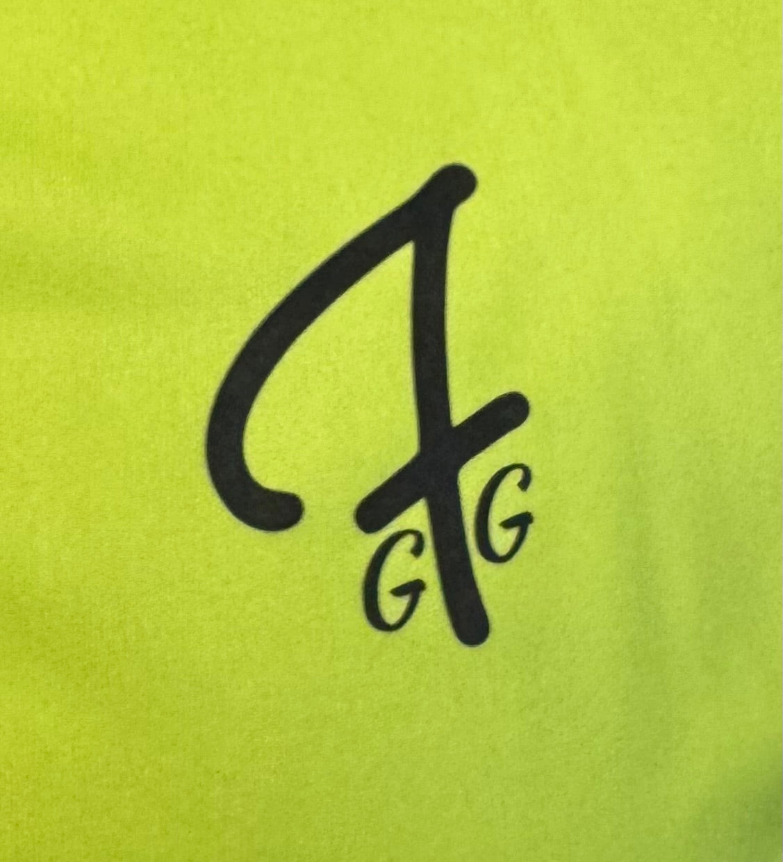 Close up of moisture-wicking fabric and GFG logo on a Green Ferret Golf polo