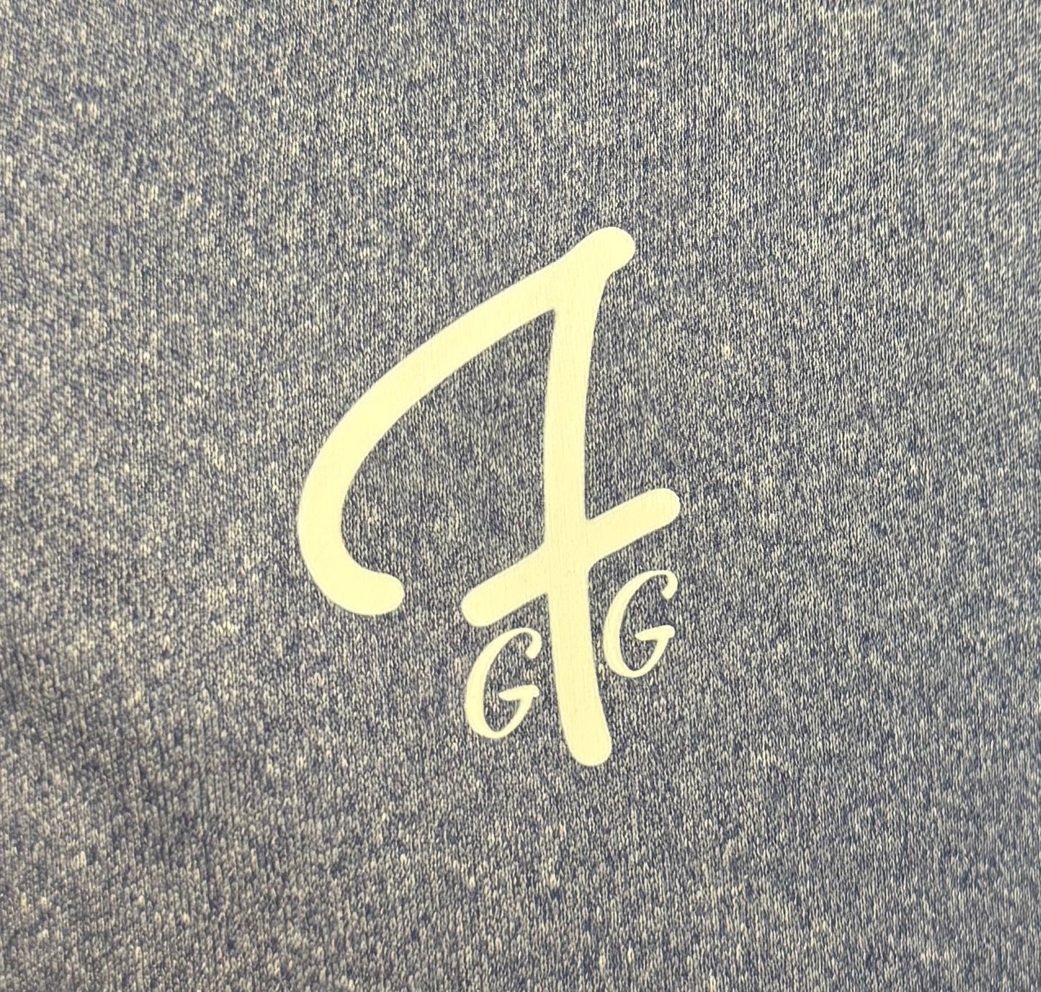 Close up of moisture-wicking fabric and GFG logo on a Green Ferret Golf polo