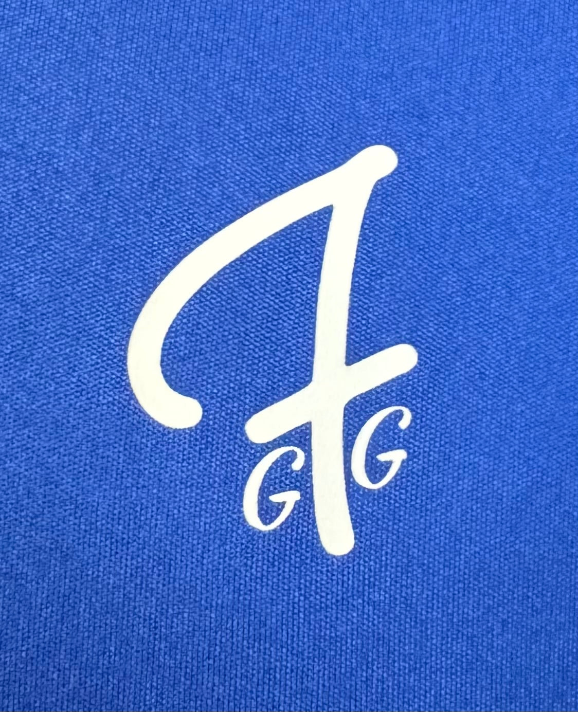 Close up of moisture-wicking fabric and GFG logo on a Green Ferret Golf polo