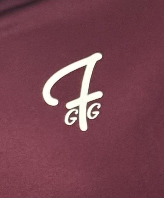 Close up of moisture-wicking fabric and GFG logo on a Green Ferret Golf polo