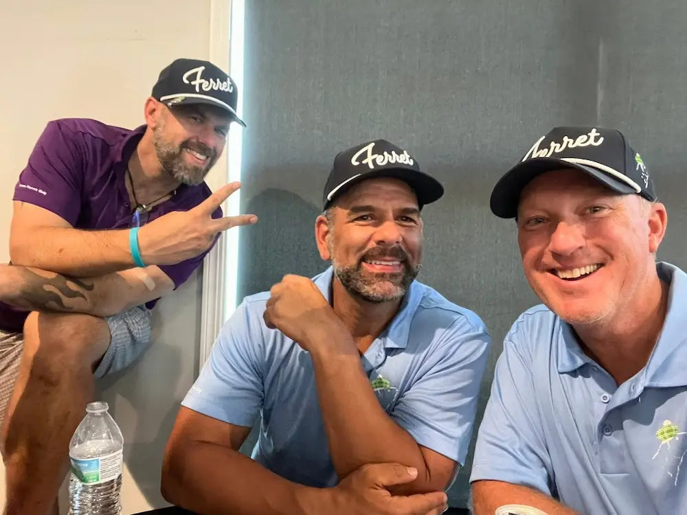 Group of Green Ferret Golf teammates enjoying a post round conversation at the Sail On; Fly High charity golf tournament.