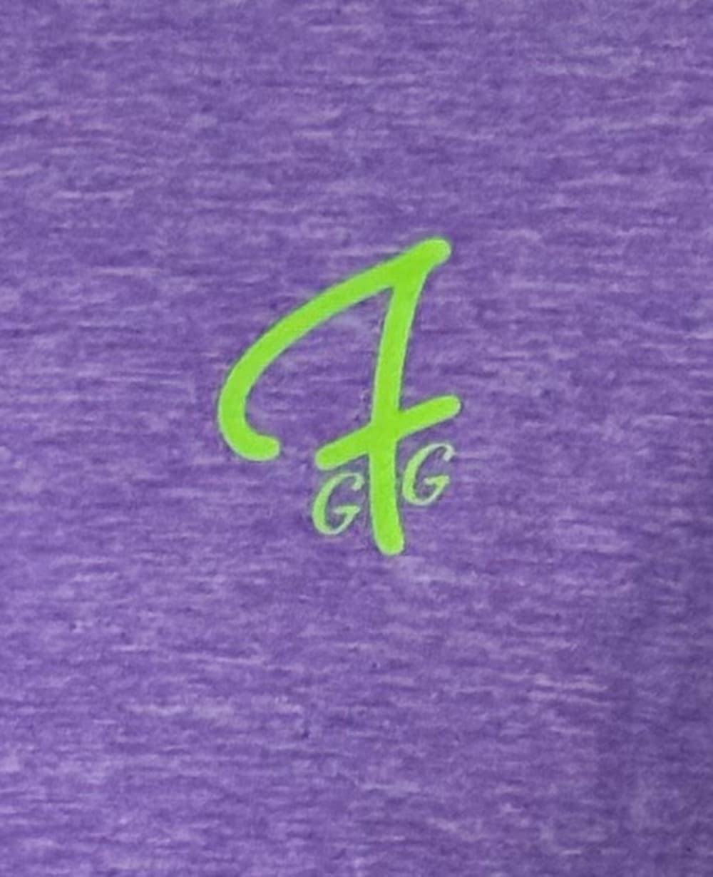 closeup of Green Ferret Golf's GFG logo on a purple tshirt from Green Ferret Golf