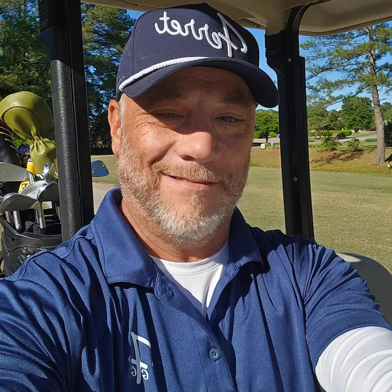 Joe wearing a Ferret Rope hat and Pro Shop Polo while golfing in North Carolina