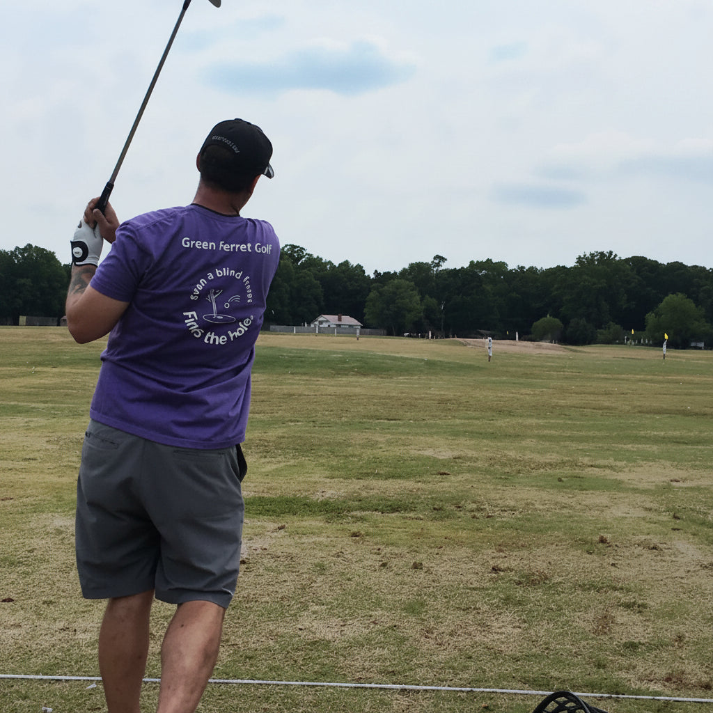 Person in an OG Ferret tshirt practicing golf swings on a driving range in Charlotte, NC