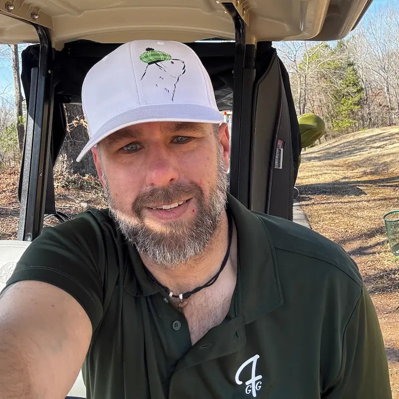 Rob wearing his Team Ferret cap and Forest Green Pro Shop Polo in a golf cart at Monroe Country Club in Monroe, North Carolina