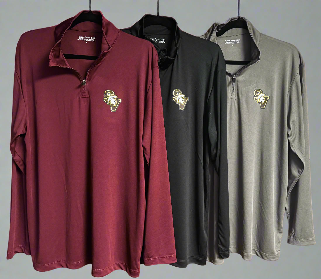 Three long-sleeve shirts in maroon, black, and gray hanging on a wooden door.