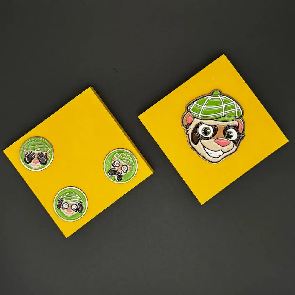 set of ball markers on a yellow post it note for size comparison. limited edition golf set from Green Ferret Golf