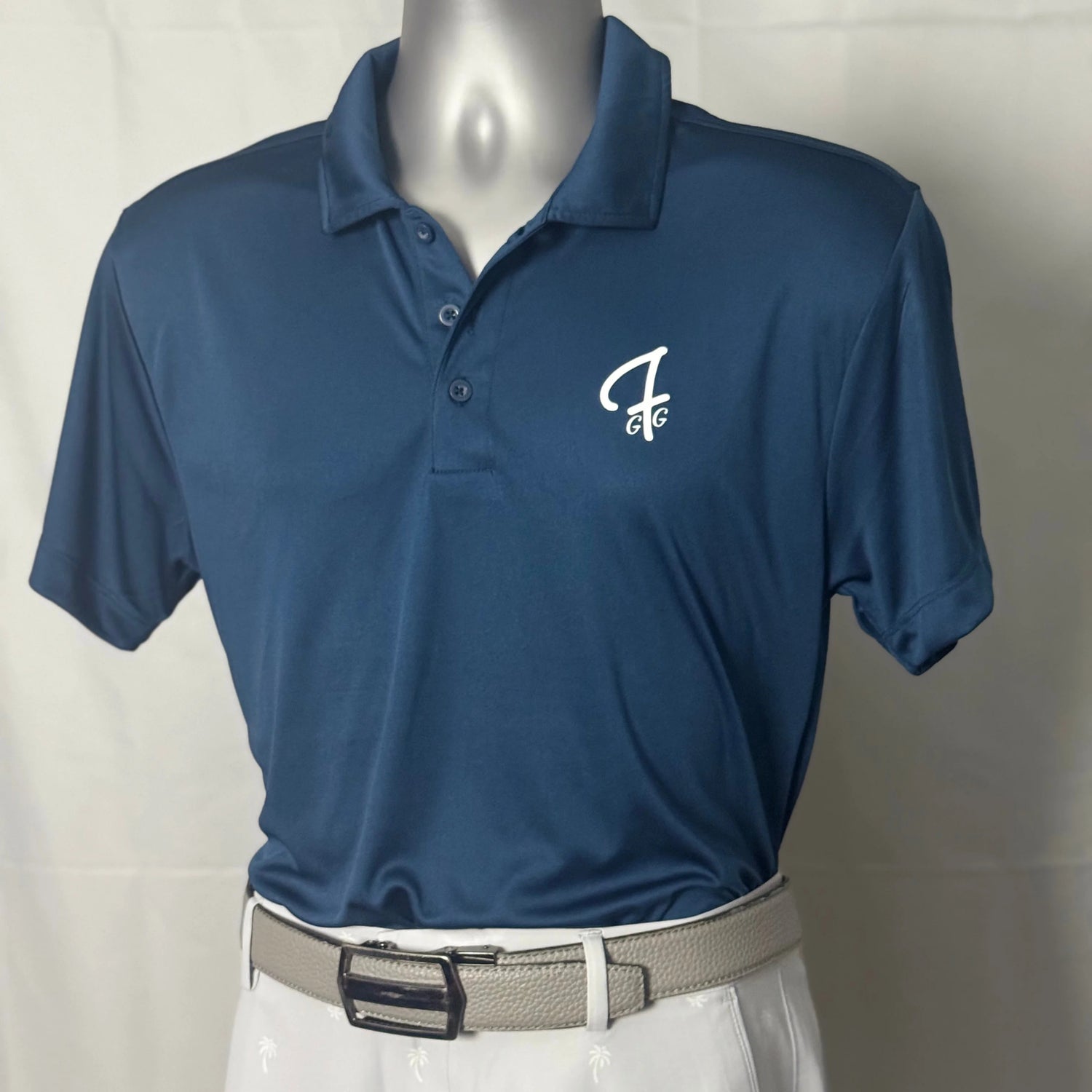 Ocean blue polo shirt with a Green Ferret Golf logo on a mannequin against a white background