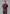 Man wearing a maroon polo shirt with a logo on a dark background
