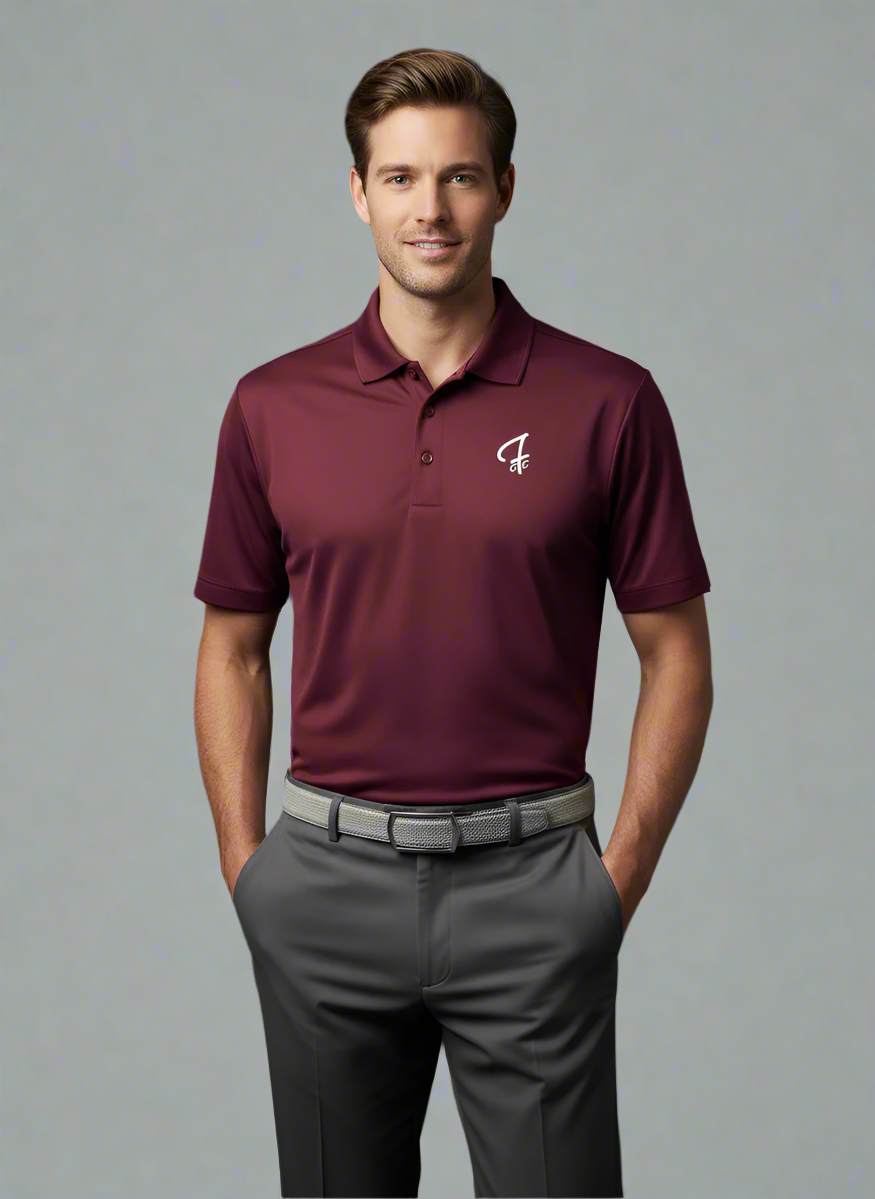 Man wearing a maroon polo shirt with a logo on a dark background
