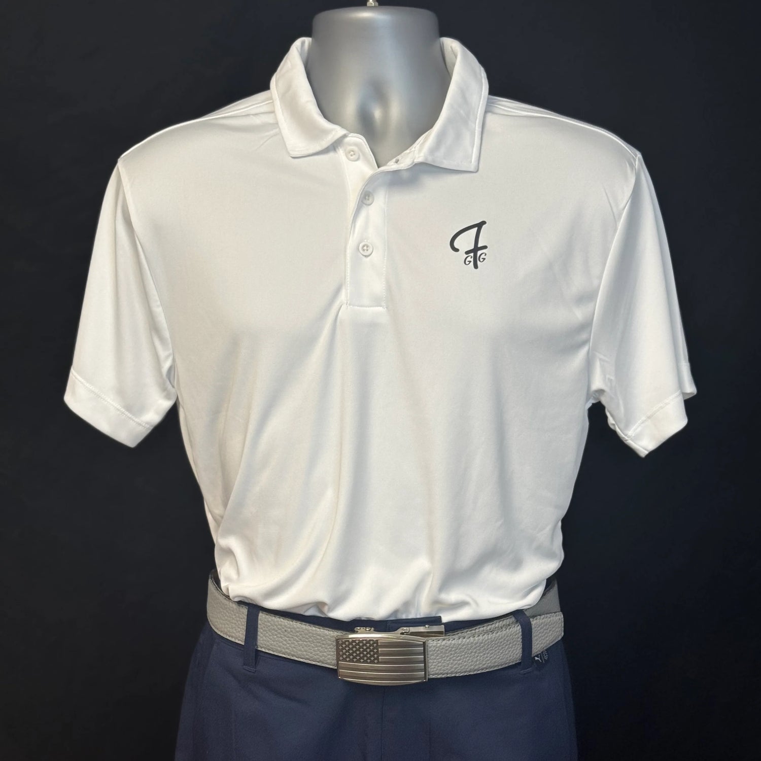 White polo shirt with a logo on a mannequin against a black background