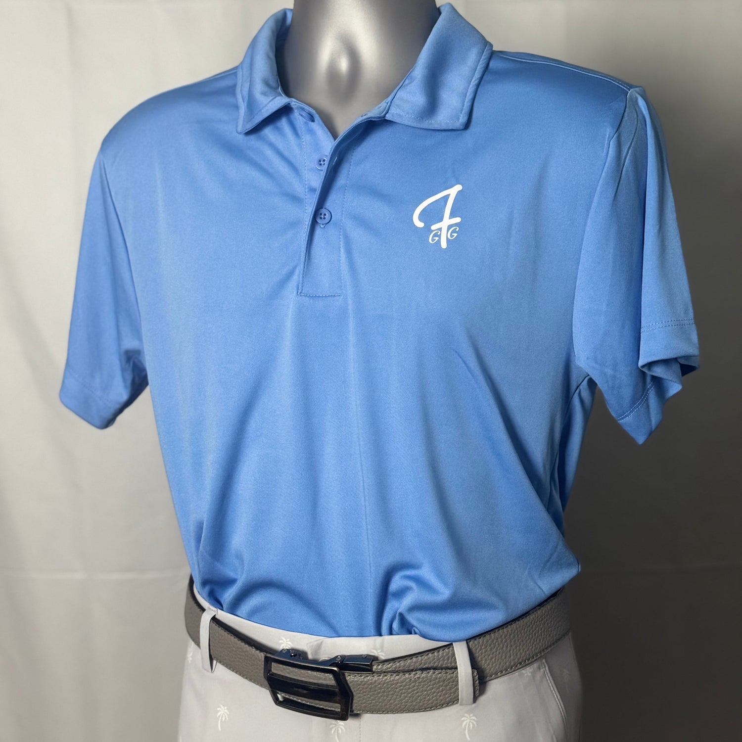 Carolina blue polo shirt with a Green Ferret Golf logo on a mannequin against a plain background