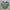 Green polo shirt with a logo on a mannequin against a dark background