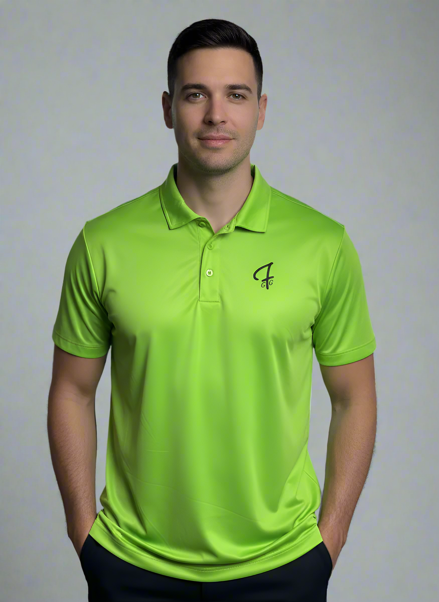 Man wearing a bright green polo shirt with a logo in an indoor setting with large windows.