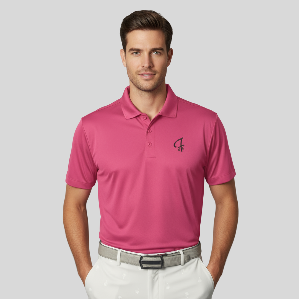 Man wearing a pink polo shirt with a Green Ferret Golf logo on a gray background