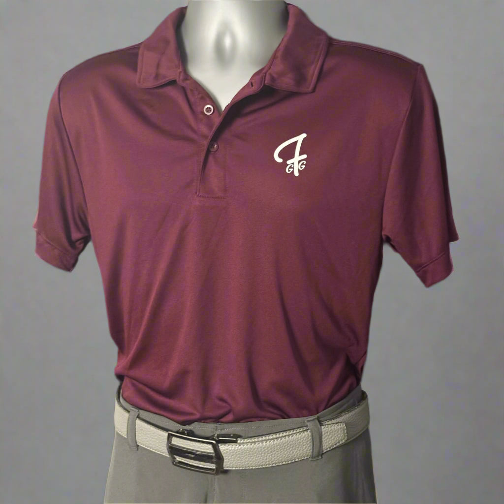 Maroon polo shirt with a Green Ferret Golf logo on a mannequin against a black background