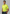Man wearing a bright yellow polo shirt with a logo on a beige background