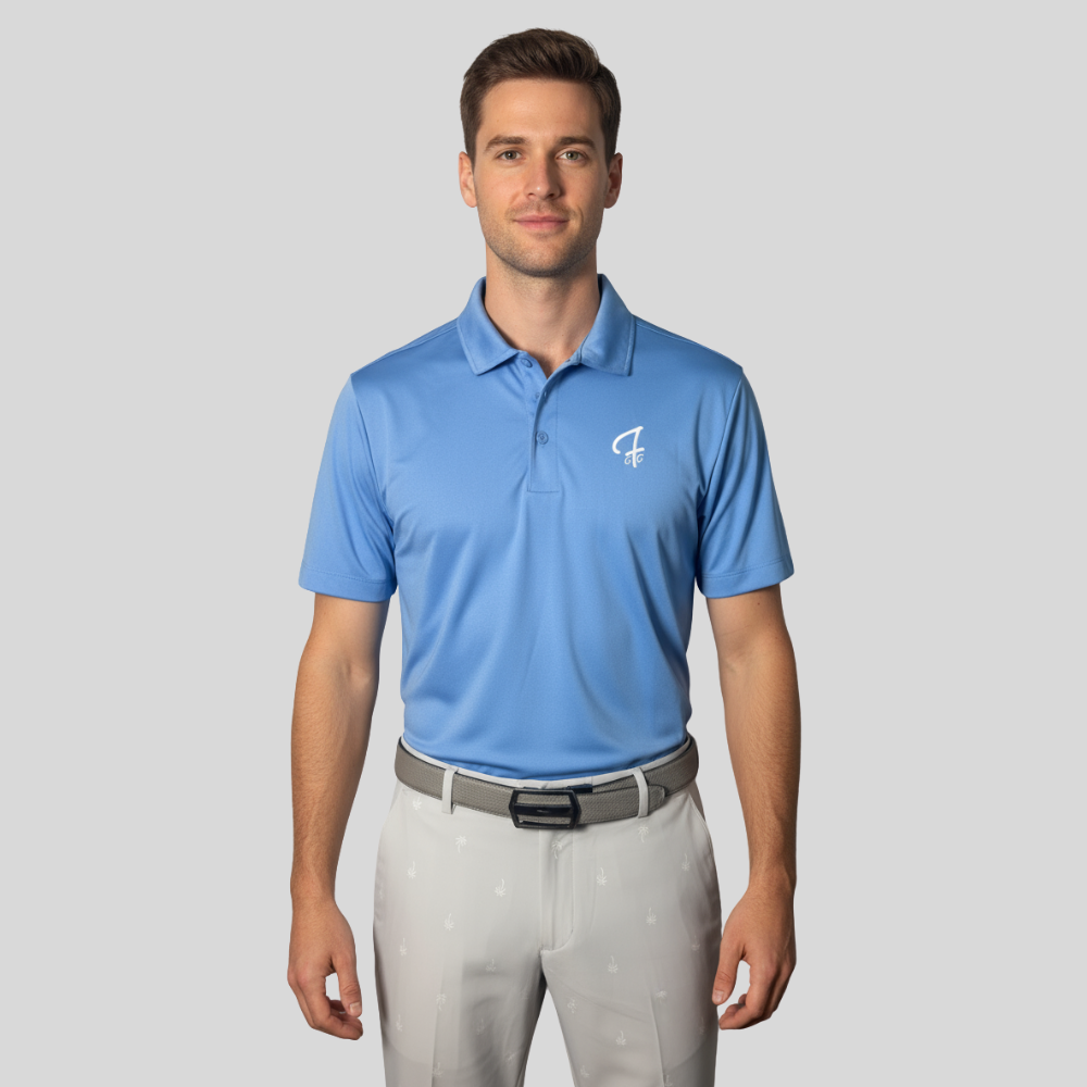 Man wearing a Carolina blue polo shirt with a Green Ferret Golf logo on a gray background