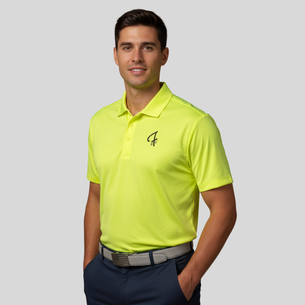 Man wearing a bright yellow golf shirt with a Green Ferret Golf logo on a gray background