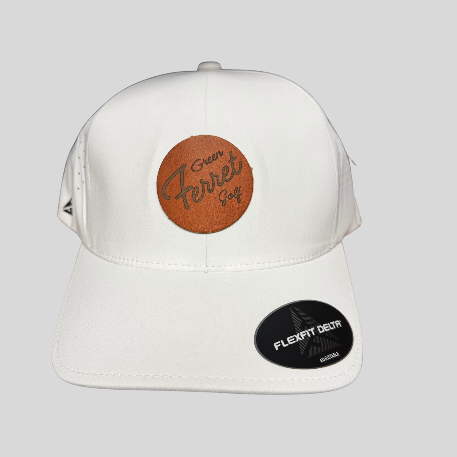 adjustable cap with a leather patch and Green Ferret Golf in script on a flexfit delta hat